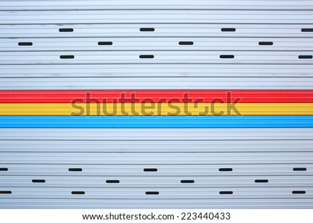 Close up gray, red, yellow, blue metal sheet slide door texture background.