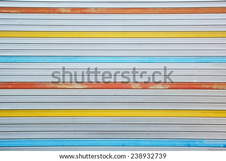 Gray, red, yellow, blue metal sheet slide door texture background.