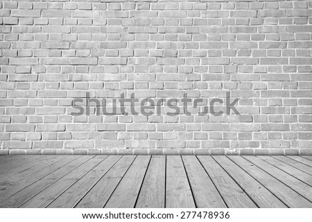Gray brick wall on wooden floor.