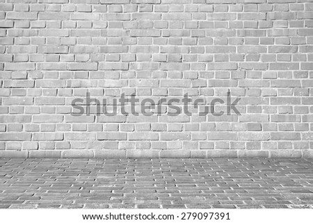 Gray brick wall on brick floor.
