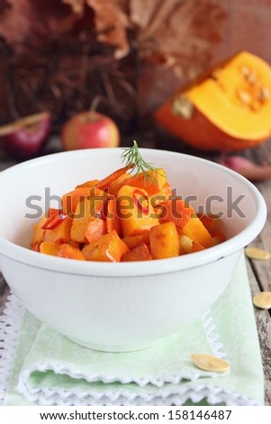 Roasted pumpkin with carrot and apple in the white retro bowl