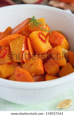 Roasted pumpkin with carrot and apple in the white retro bowl