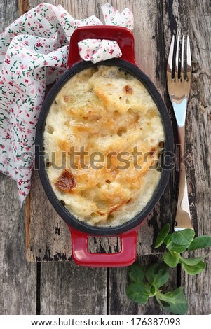 Portion of homemade potato-cauliflower gratin casserole with cheese. Close up.