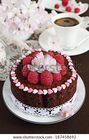 Delicious homemade chocolate cake with raspberry-flower garnish.Selective focus.