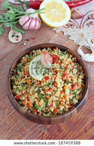 Quinoa salad with vegetables mix, herbs and lemon.
