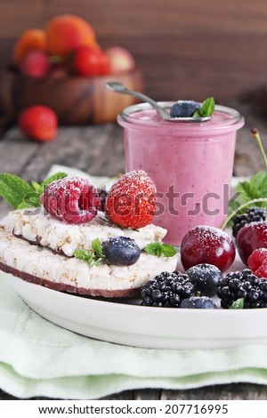 Breakfast with dietary rice waffles, berry yogurt and fresh berries . Selective focus.