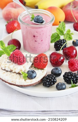 Healthy breakfast with dietary rice waffles, berry yogurt and fresh berries.Selective focus