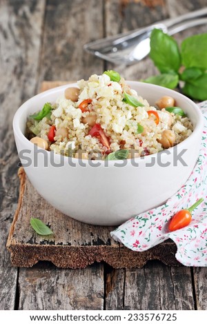 Quinoa salad with vegetables mix, chickpea and cheese.Selective focus.