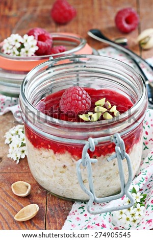Overnight oats with fresh raspberry and pistachio. Healthy eating. Selective focus.