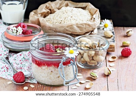 Overnight oats with fresh raspberry and pistachio. Healthy eating. Selective focus.