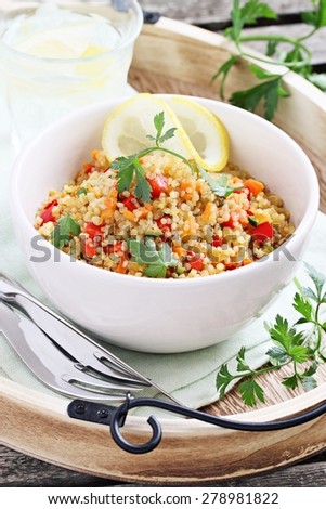 Quinoa salad with vegetables mix,lemon and parsley. Selective focus.