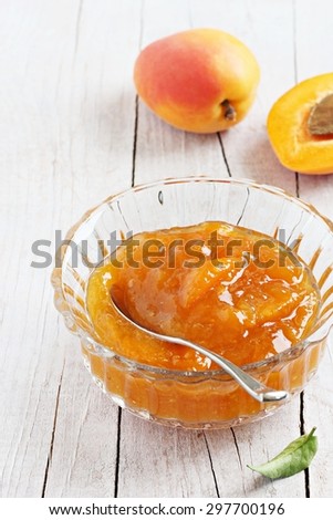 Homemade apricot jam on a rustic wooden table.Selective focus