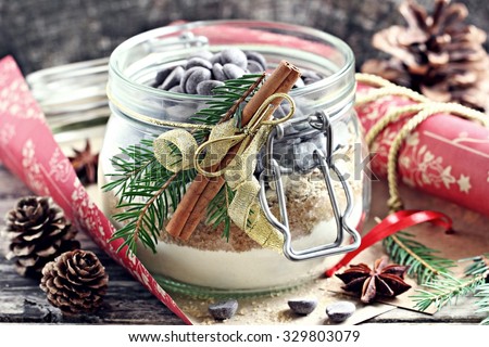 Edible gift Idea: oatmeal cookies mix in the glass jar on a rustic wooden table.Toned image.Selective focus