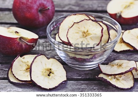 Sun dried apple chips on a rustic wooden table.Healthy snack.Selective focus