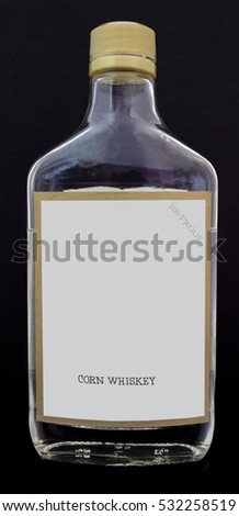 White lightning moonshine pint bottle with blank copy space copy space label. Black background. Vertical.