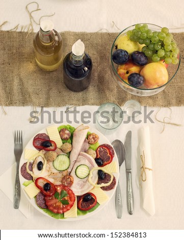 Rustic rural table with cold dish food, brandy and fruit dish