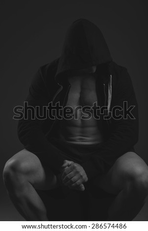 muscular athlete man, black and white in hood