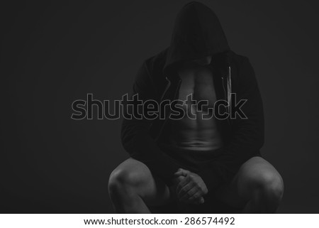 muscular athlete man, black and white in hood