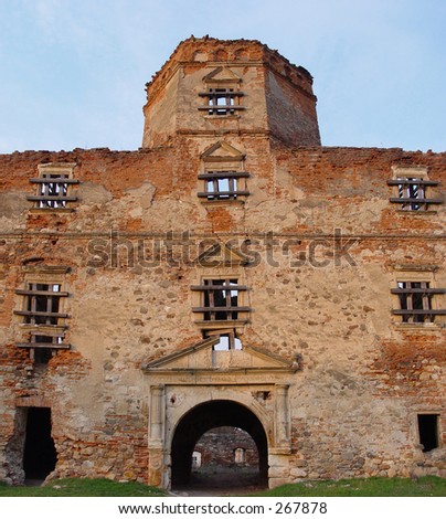 ancient abandoned building with visible latin words on the gate