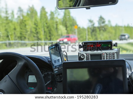 NOKIA, FINLAND - MAY 26. Finnish police is doing traffic enforcement on the side of a road on May 2014. Police is measuring speeding with stalker radar in Skoda Octavia.