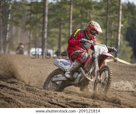 LAITILA, FINLAND - APRIL 20: A motocross driver speeds up fast in a dirt track . Image taken in West Cross Weekend championships in Laitila, Finland in April 20th 2014.
