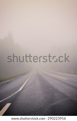 Life is a journey as they say. An image of a very foggy road in autumn. Image has a strong vintage effect.