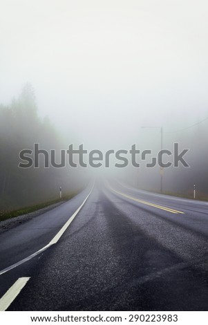 Life is a journey as they say. An image of a very foggy road in autumn. Image has a strong vintage effect.