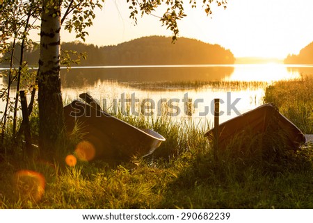 A couple of boats in the sunset in Finland in a peaceful evening.