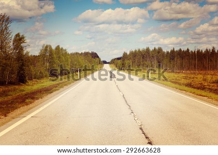 Life is a journey as they say. This image describes it completely showing just an empty road in the summer time. Image has a vintage effect.
