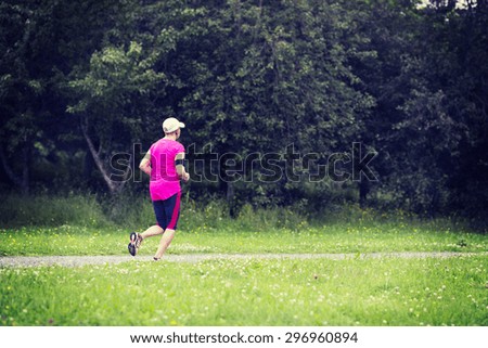 A woman running in the rain. Image has a vintage effect.