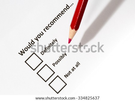 A white paper with choices and a red pencil. The survey form is asking whether a person would recommend the service for example for someone. The focus point is on the red pen tip.