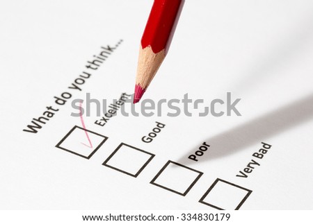 A survey form filled with a red pencil. The form is asking for persons opinion on something for example for service quality. The answer is excellent. The focus point is on the red pen tip.