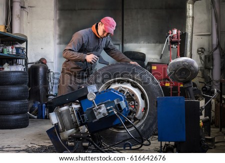 mechanic is repairing truck wheels