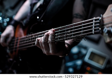 Guitar neck close-up on a concert of rock music in the hands of a musician
