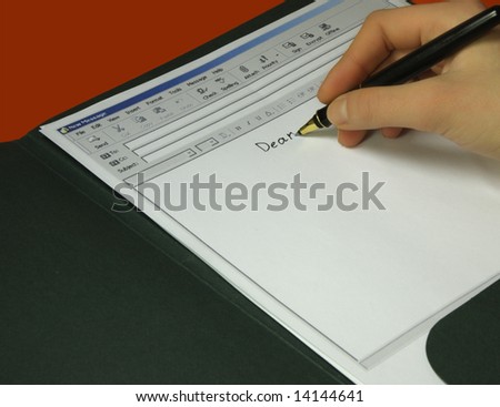 Hand writes email on the sheet of paper