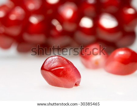 Macro of pomegranate seeds isolated on white
