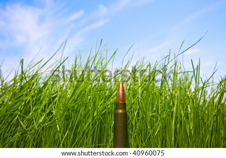 Abstract image of cartridge over blue sky and grass background - environment protection concept