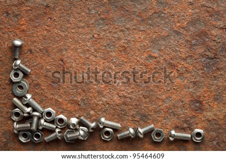 Bolts and nuts on rusted iron plate with copy space for text