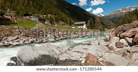 house on the river in the mountains, panorama. Austria, Alps