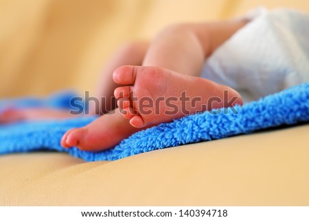 Two little feet Baby feet on the blue blanket