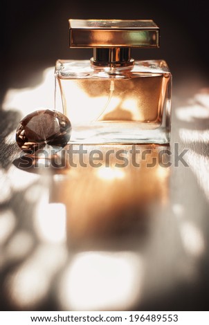 Golden Perfume Golden perfume bottle on a natural background with crystal