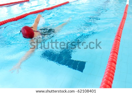 young woman swim on indoor pool. freestyle mode.