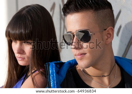 Young couple urban fashion close-up portrait focused on man