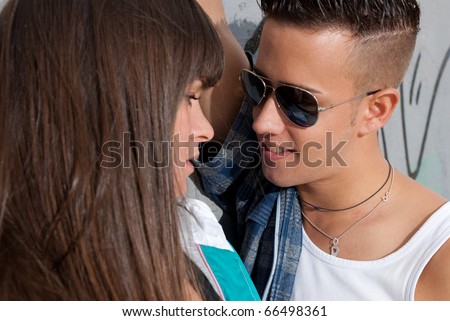 Young couple urban fashion close-up portrait focused on man