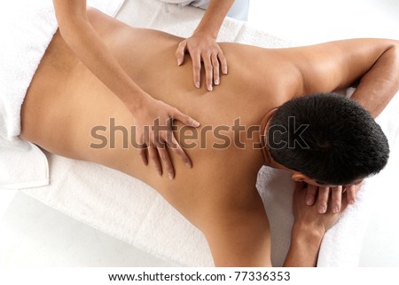 Unrecognizable man receiving massage relax treatment close-up from female hands