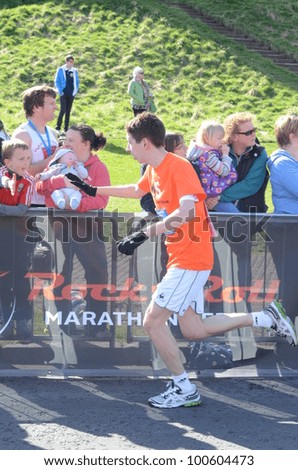 EDINBURGH - APRIL 15: a man participates in the inaugural Rock \'n\' Roll Half Marathon on April 15, 2012 in Edinburgh, Scotland.