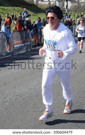 EDINBURGH - APRIL 15: a runner dressed as Elvis Presley participates in the inaugural Rock \'n\' Roll Half Marathon on April 15, 2012 in Edinburgh, Scotland.