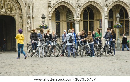 BRUSSELS, BELGIUM - JUNE 13: tourists take part in a bicycle tour in the Grand Place on June 13, 2012 in Brussels, Belgium. The Brussels capital region received 3,166,224 tourists in 2011.