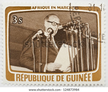 GUINEA - CIRCA 1979: a stamp from Guinea shows image of a foreign dignitary giving a speech, from the Africa in Motion series, circa 1979