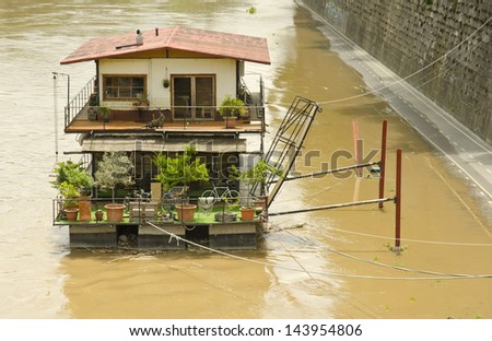 ROME - JUNE 5: a river boat on the flooded Tiber River on June 5, 2013 in Rome, Italy. Central Europe experienced some of the worst flooding in centuries in the first week of June 2013.